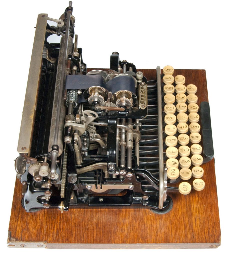 Left side view of the Munson 1 typewriter on a square wooden base, small file. (sold)