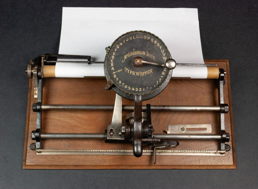 McLoughlin Brothers typewriter with paper loaded in.