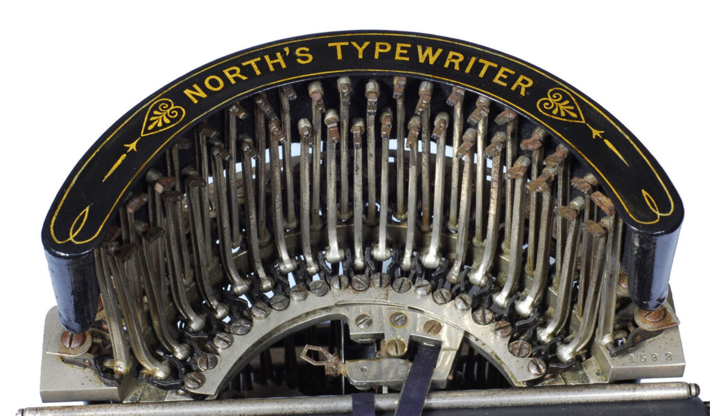 Top view of the curved type-bar retainer on the Norths typewriter.