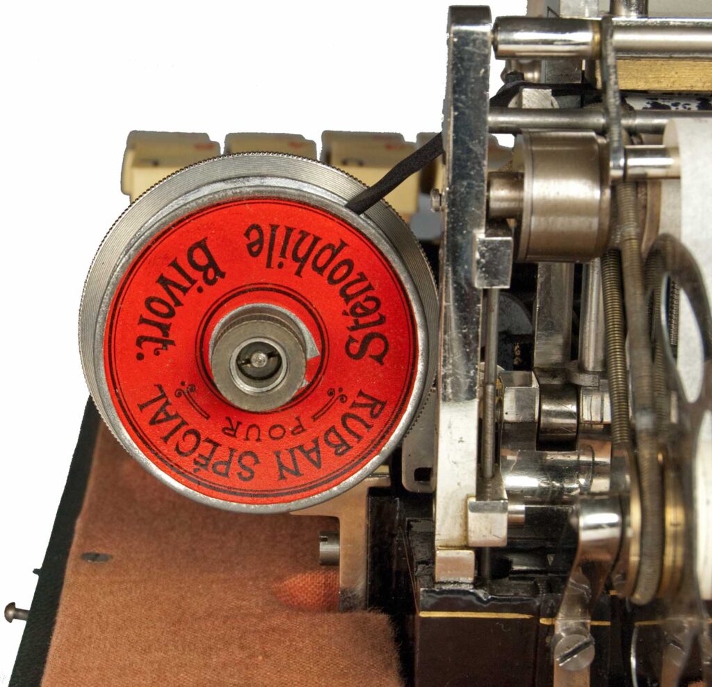 View of the decorated ribbon spool on the Stenophile shorthand typewriter.