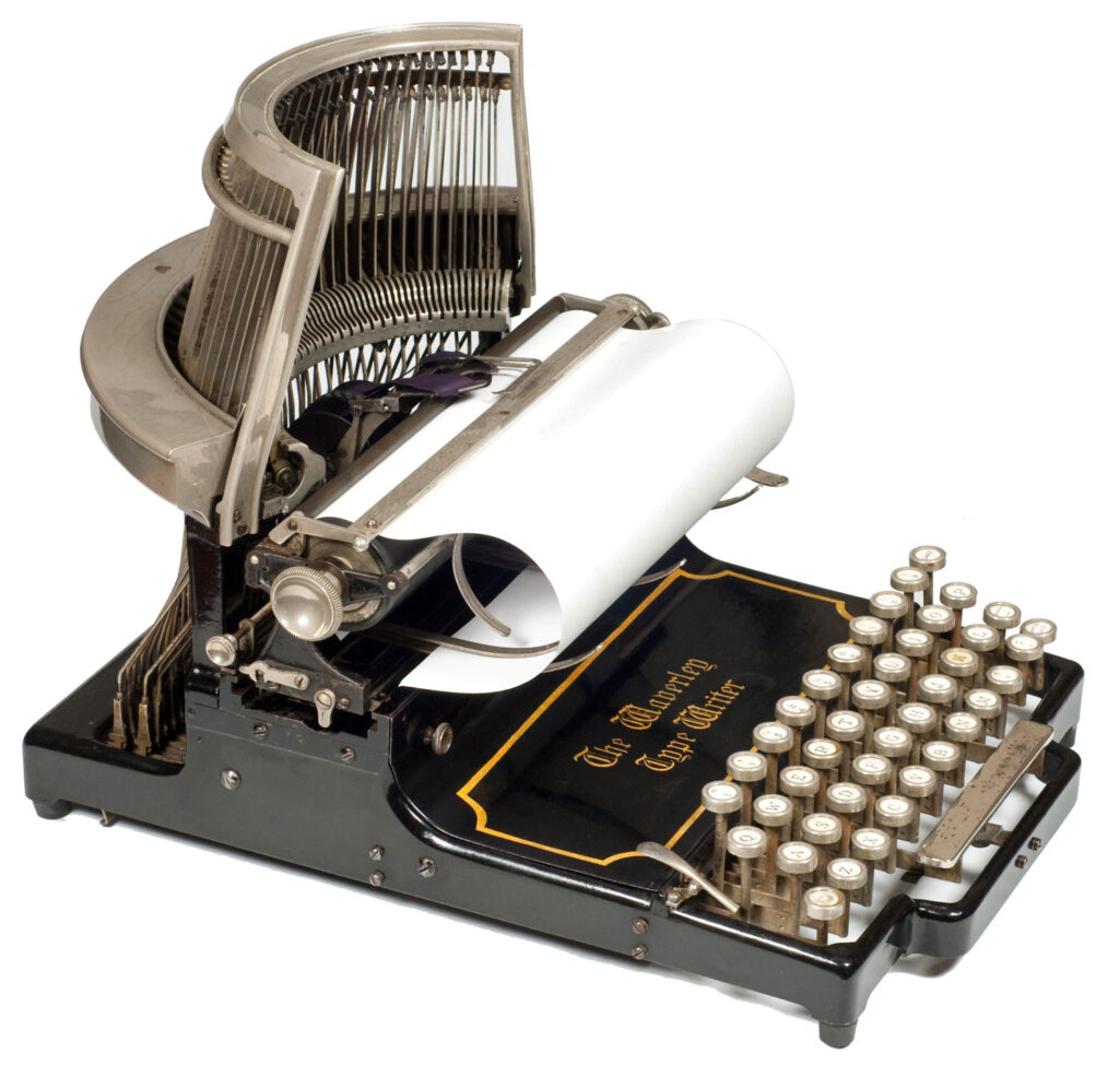 View of the Waverley typewriter shown with a sheet of paper loaded in the carriage ready for typing.
