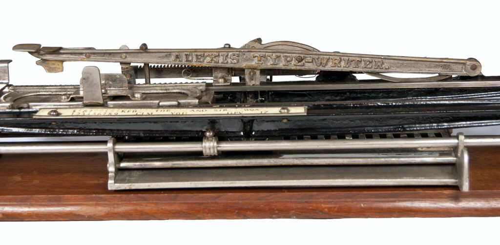 Low front view of the Alexis typewriter showing the name plate.