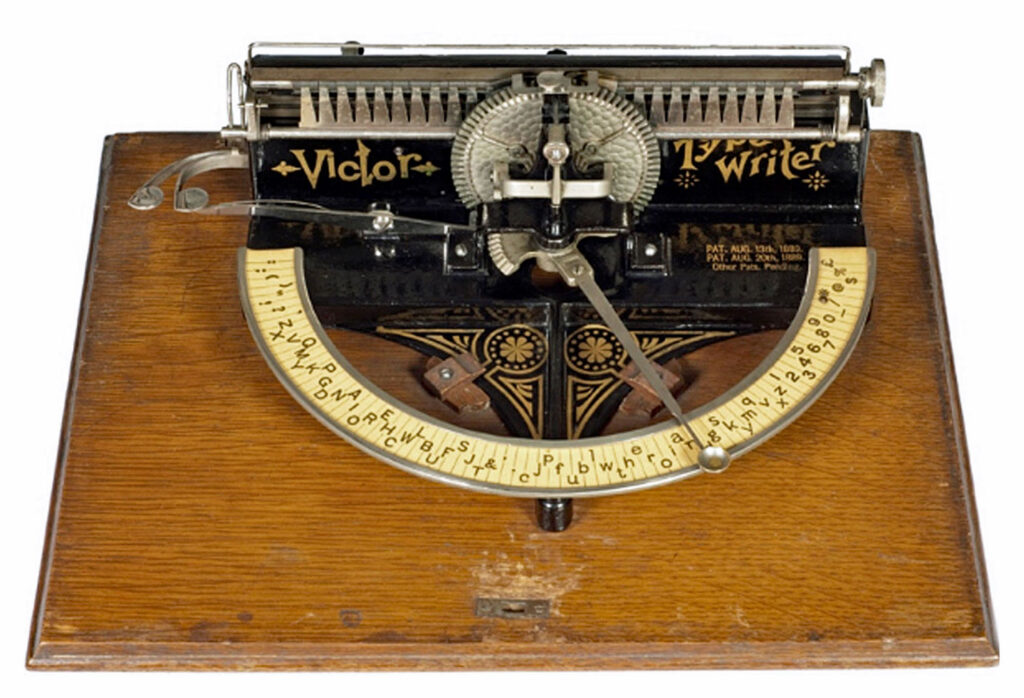 Photograph of the Victor typewriter on its wooden base.