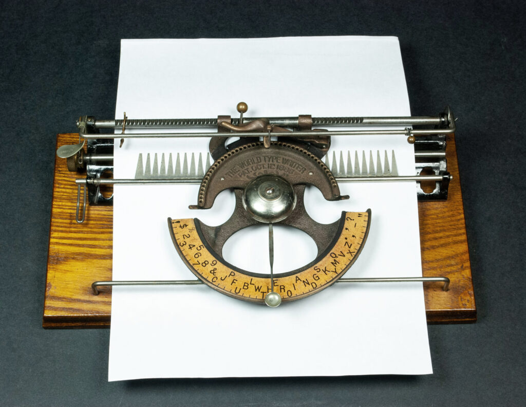 World 1 typewriter with a sheet of paper loaded in for typing.