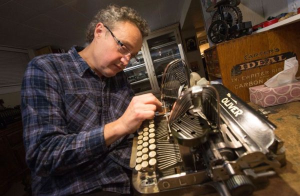 Martin adjusting an Oliver 2 typewriter.
